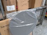 a pile of boxes and a chair in a warehouse