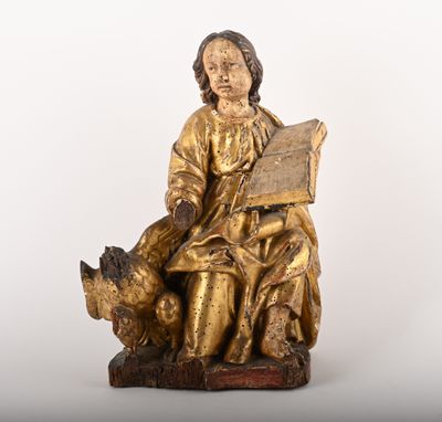 an image of a statue of a man sitting on a bench reading a book