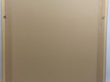 an empty picture frame sitting on top of a white surface