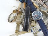 a pile of assorted watches and watches on a white surface