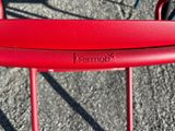 a red chair that has a red handle on it