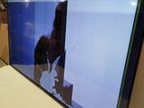 a flat screen tv sitting on a bed in a room