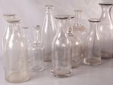 many glass bottles that are lined up on a table