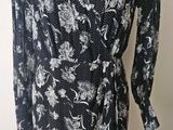 the dress is black and white with white flowers on it