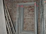 a room with a ladder, ladders, and a door in it