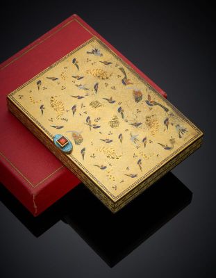 a gold and red box with a floral design on it