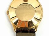 a close up of a watch on a white surface