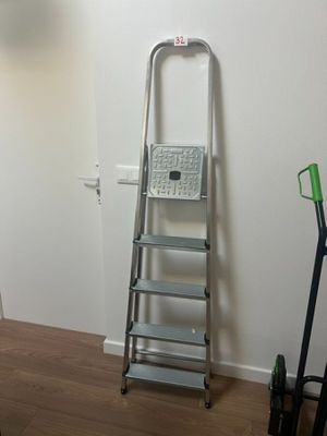 a ladder that is leaning against a wall in a room