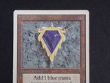 a picture of a card with a purple diamond on it