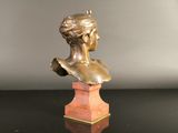 bronze bust of a woman on a marble base