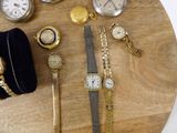 a lot of watches and other watches on a wooden table