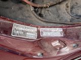 a close up of a car ' s engine with a number plate on it