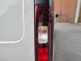 a close up of the tail light of a white van