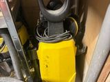 a yellow machine that is sitting in the corner of a room