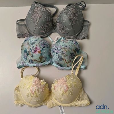 several bras are lined up on a white surface