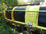 a yellow and black train that is sitting in the grass