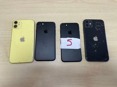 three iphones are sitting next to each other on a table