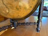 a large globe sitting on top of a wooden table