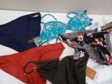 a lot of underwear that are laying out on a bed