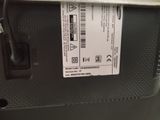 a label on the back of a suitcase that is sitting on the floor