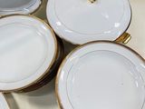 many plates and bowls that are sitting on a table