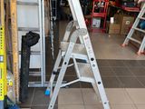 two ladders that are sitting in the middle of a room