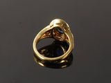 a close up of a gold ring with a blue stone in it
