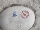 a white vase with a blue and red design on it