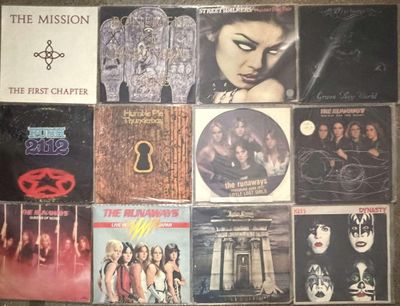 the album covers of the first chapter of the mission are displayed on a wall