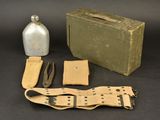 a box, a bottle, and a pair of scissors sitting on a table