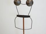 a metal sculpture of two balls on a wooden stand