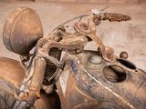 a close up of a motorcycle with a rusted handlebar