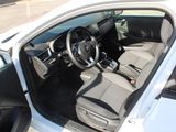 the interior of a white car with the door open and the steering wheel in the passenger seat