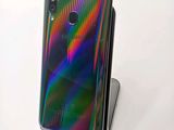 the back view of a phone with a rainbow - colored case