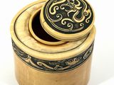 a wooden box with a lid that has a design on it