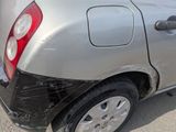 a silver car that has been damaged and is sitting in the parking lot