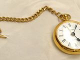 a gold pocket watch with a chain attached to it