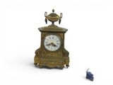 a small clock that is sitting on the ground