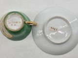 a tea cup and saucer sitting on a table