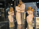 three figurines of a man and a woman on display