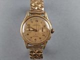 an image of a gold wrist watch on a table