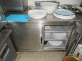 a kitchen with a lot of plates and bowls on the counter