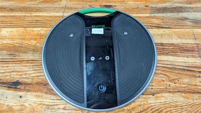 a black and green vacuum cleaner on a wooden floor