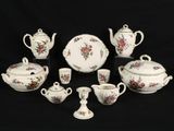 an image of a group of porcelain dishes and cups on a black background