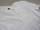 a white shirt that is laying on a table