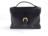 a black leather handbag with a gold buckle on the front