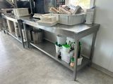 a metal table with a bunch of containers on top of it
