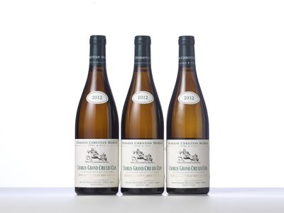 three bottles of wine sitting on top of a table next to each other