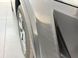 a close up of a car ' s front bumper with a denting on it