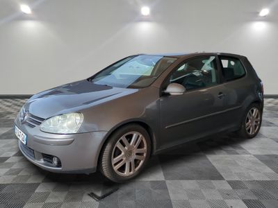 a picture of a silver volkswagen golf in a garage